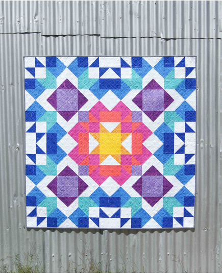 Aurora Quilt Pattern by Tied With A Ribbon - Quilt hung on corregated iron for effect