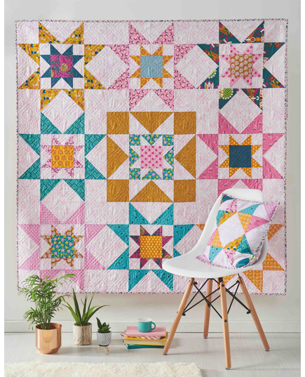 Galaxy Twist Quilt Pattern by Tied With A Ribbon - Completed quilt and pillow on display