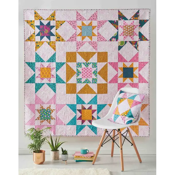 Galaxy Twist Quilt Pattern by Tied With A Ribbon - Completed quilt and pillow on display