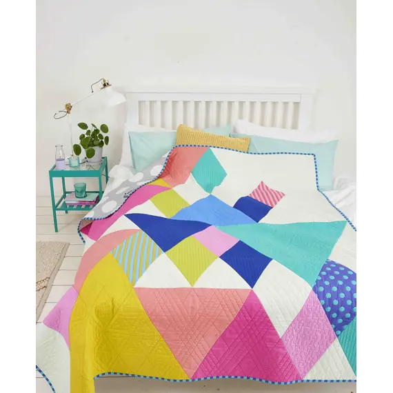 End Game Quilt Pattern by Tied With A Ribbon - made quilt shown on a bed